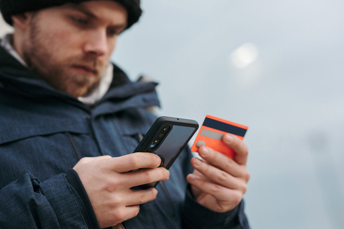 man making a credit card purchase on his smartphone